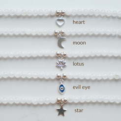 Silver charms: heart, moon, lotus, evil eye and star