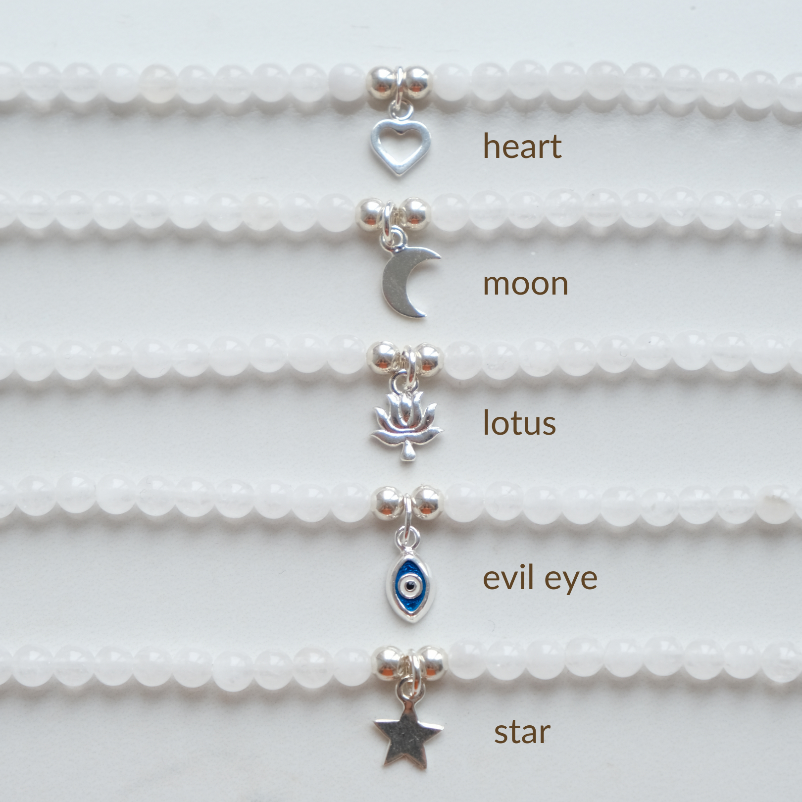 Silver charms: Heart, moon, lotus, evil eye, star