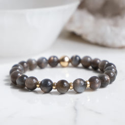 An 8mm black moonstone gemstone bracelet with gold filled accessories