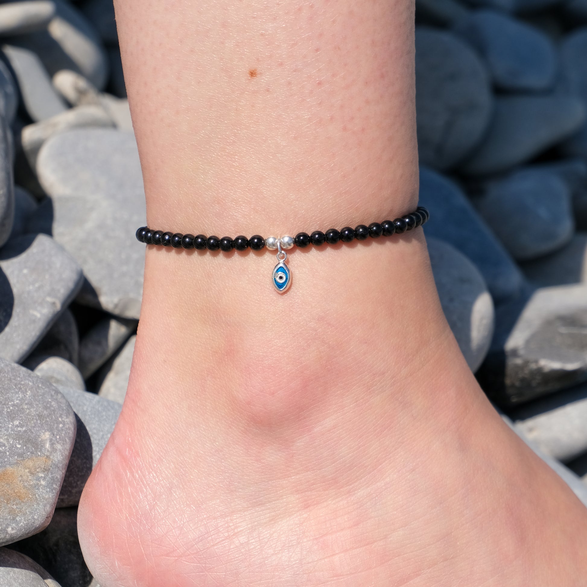 Black tourmaline crystal anklet with evil eye charm