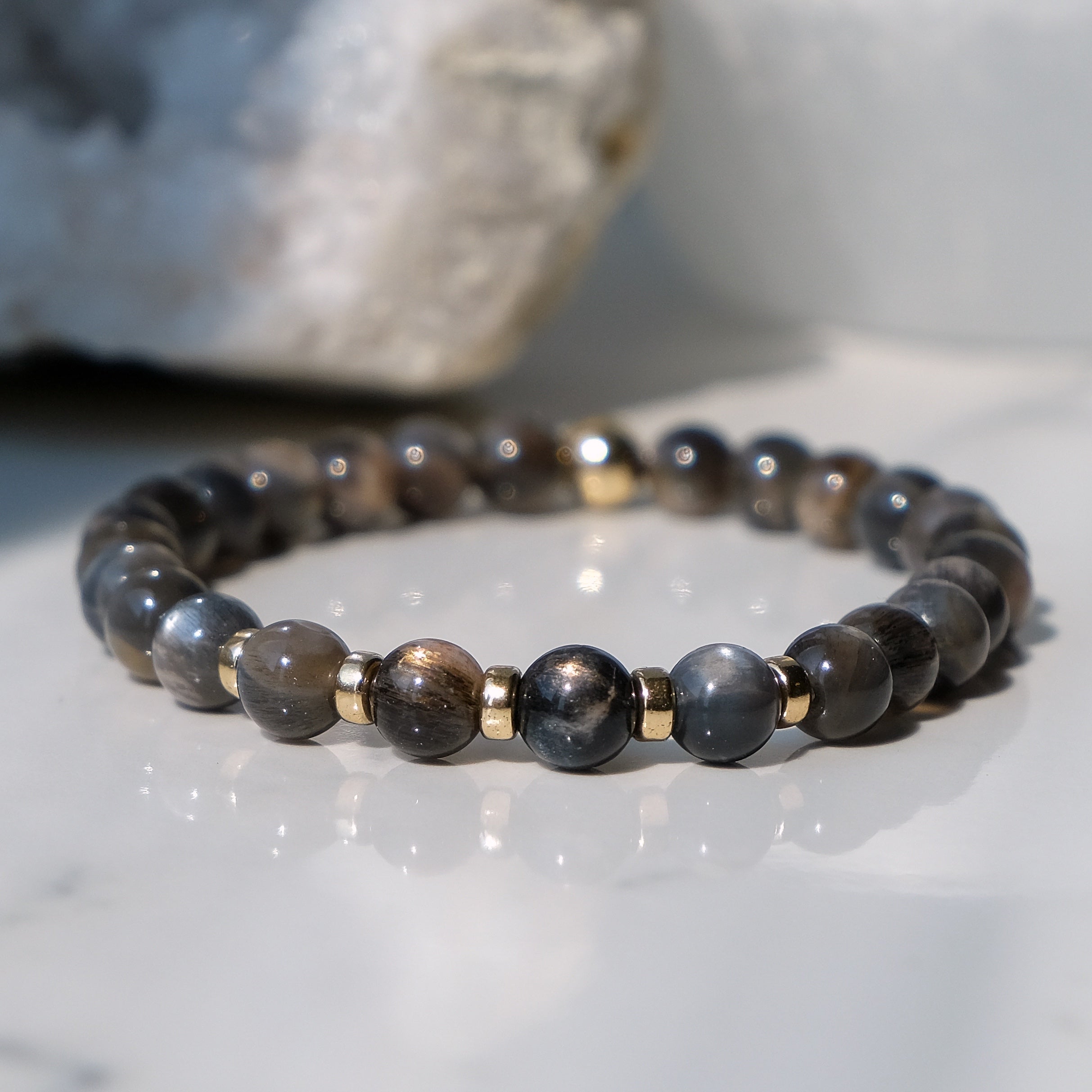 A black moonstone bracelet in 6mm beads with gold filled accessories