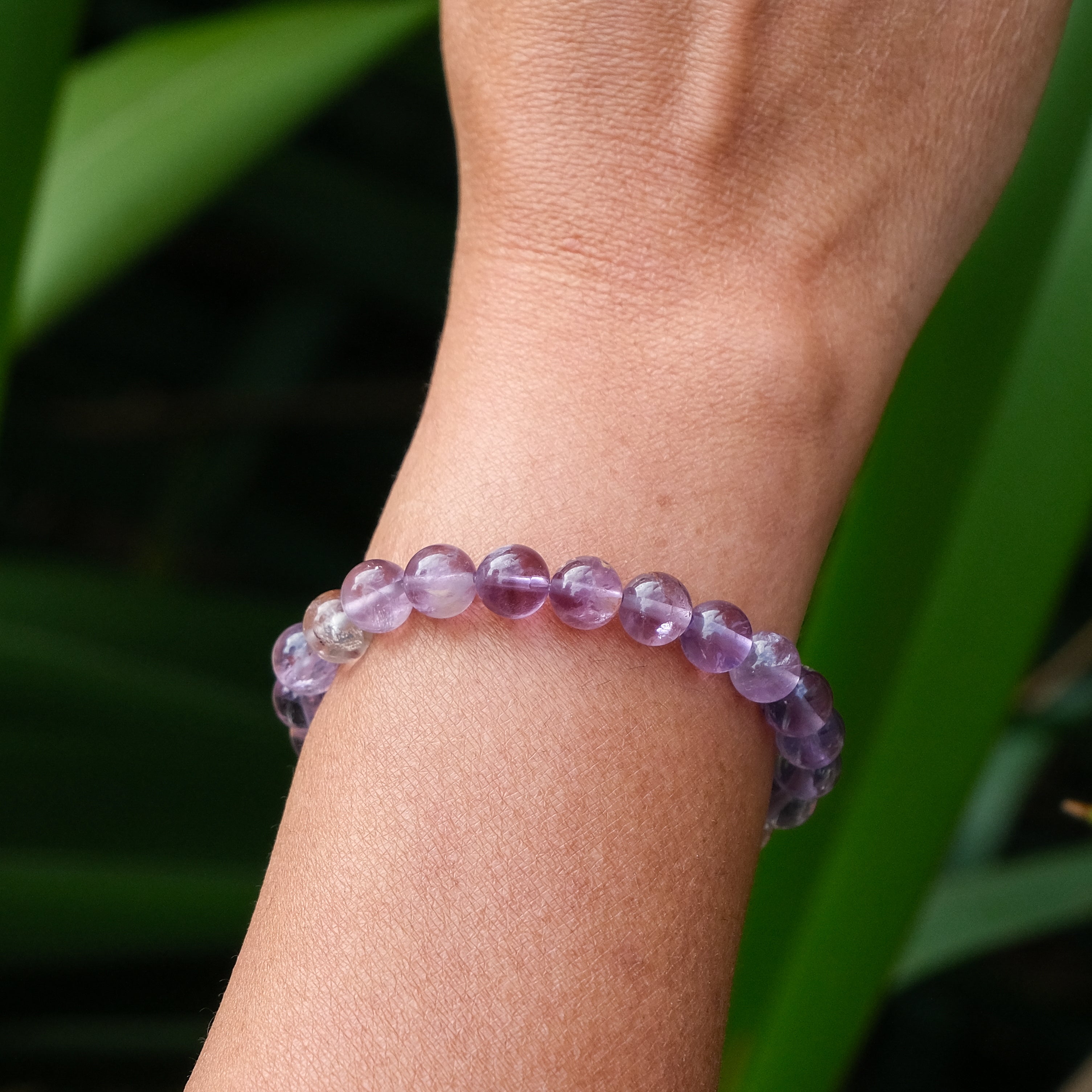 A phantom amethyst gemstone bracelet worn on a model's wrist