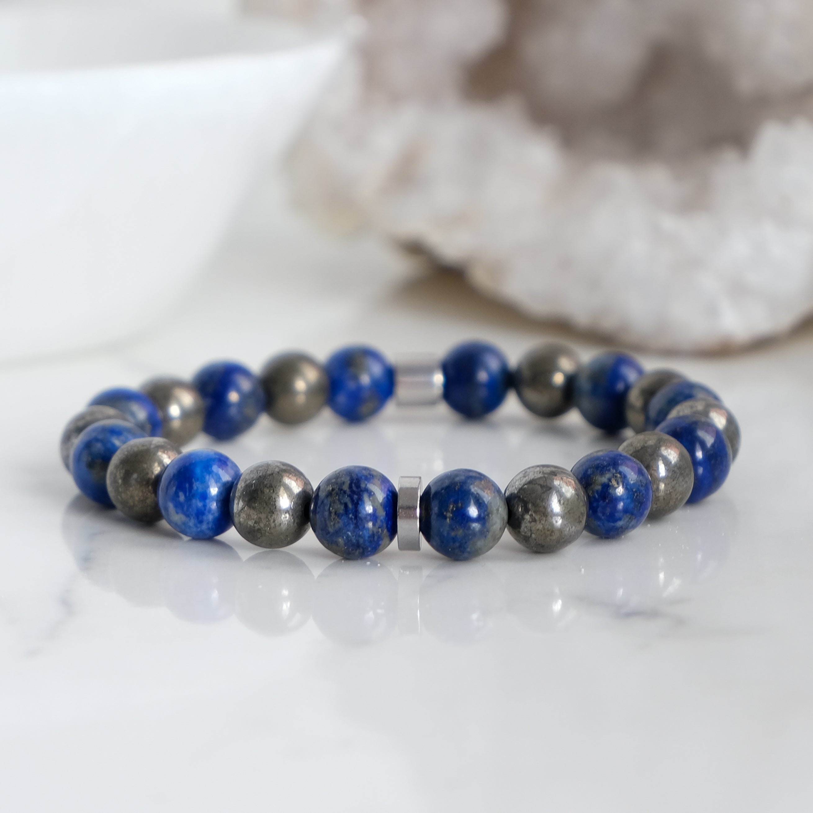 A 8mm lapis lazuli and pyrite gemstone bracelet with stainless steel accessories