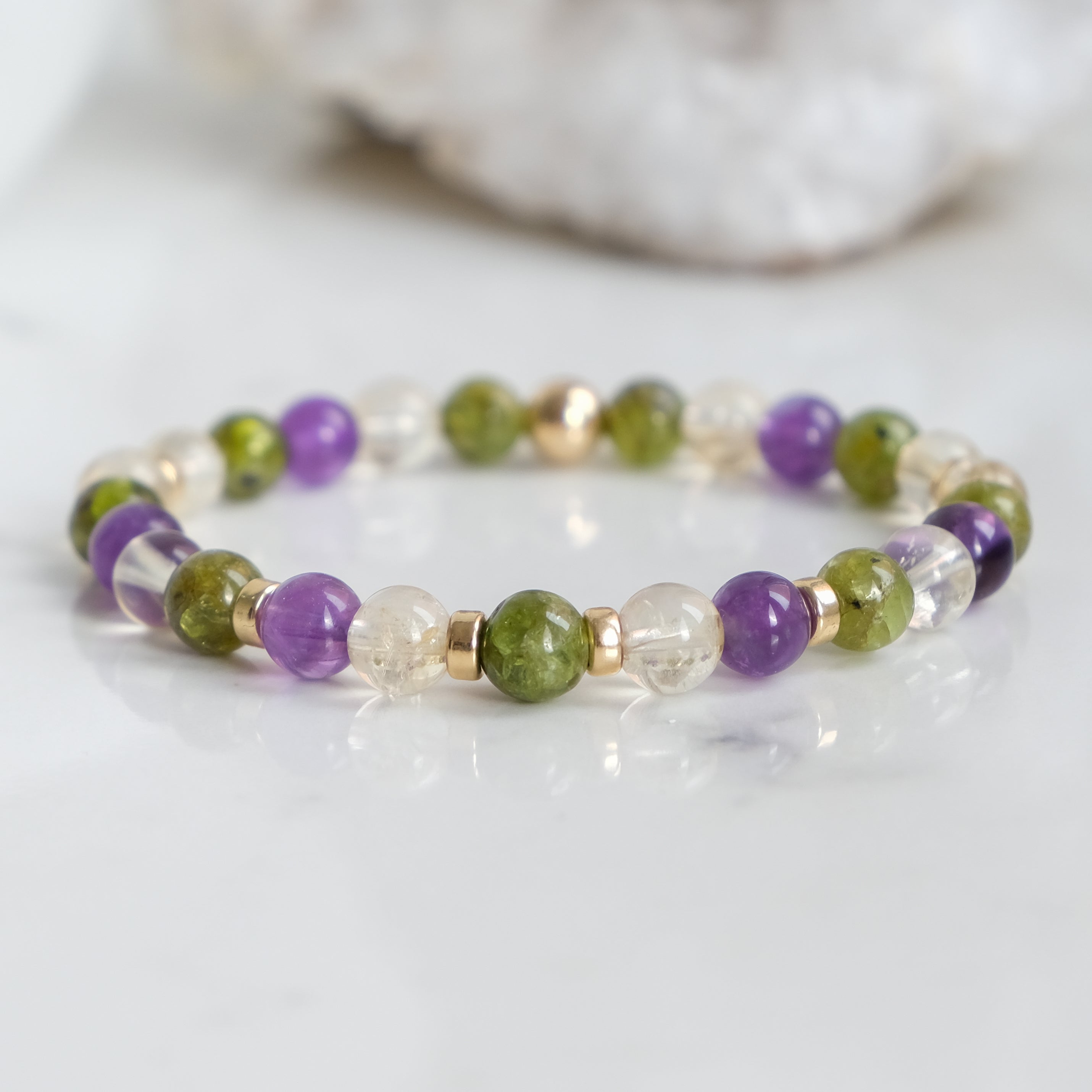 A 6mm peridot, amethyst and citrine gemstone bracelet with gold filled accessories