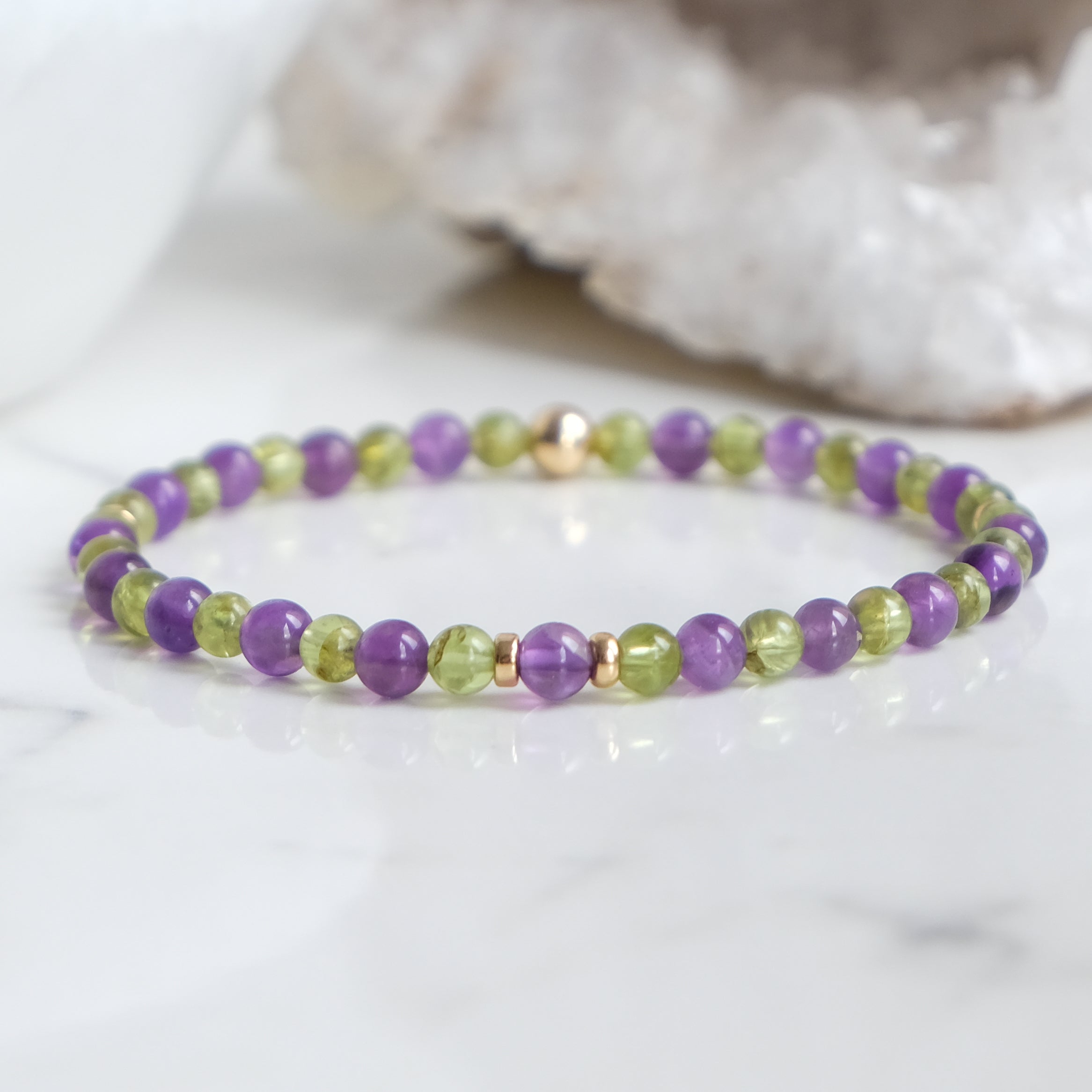 A 4mm peridot and amethyst gemstone bracelet with gold filled accessories