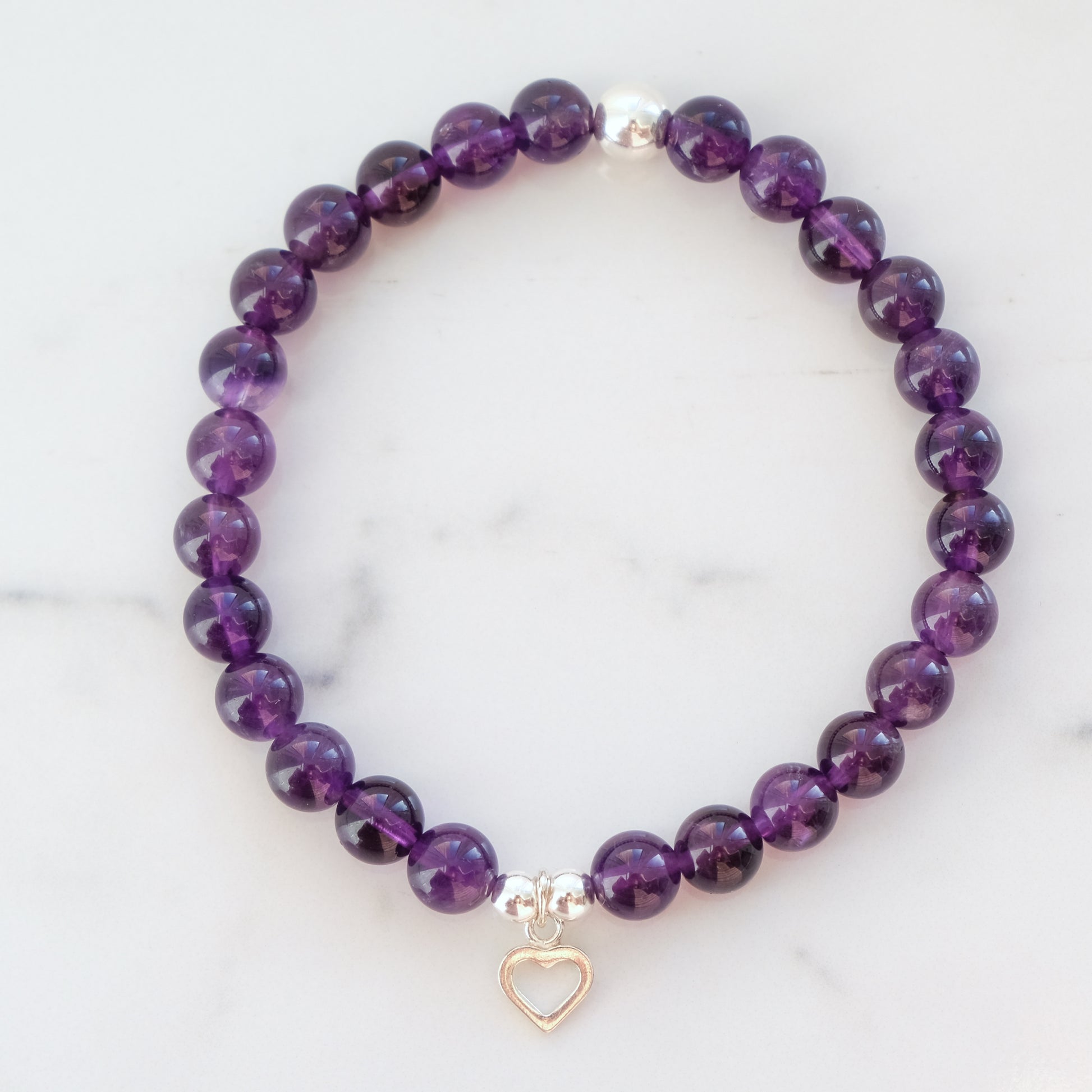 Amethyst gemstone bracelet in 6mm with silver heart charm.