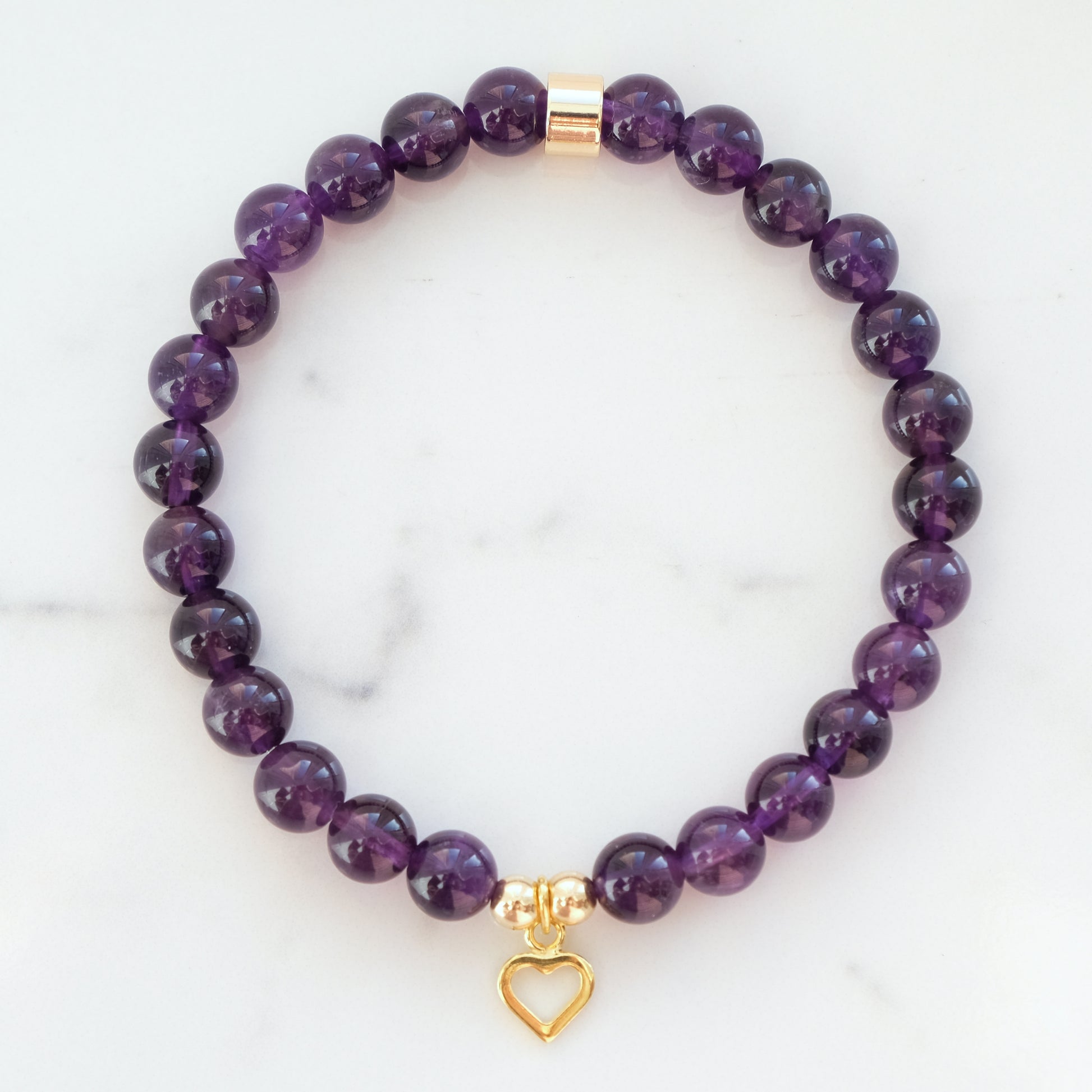 Amethyst gemstone bracelet in 6mm with gold heart charm.