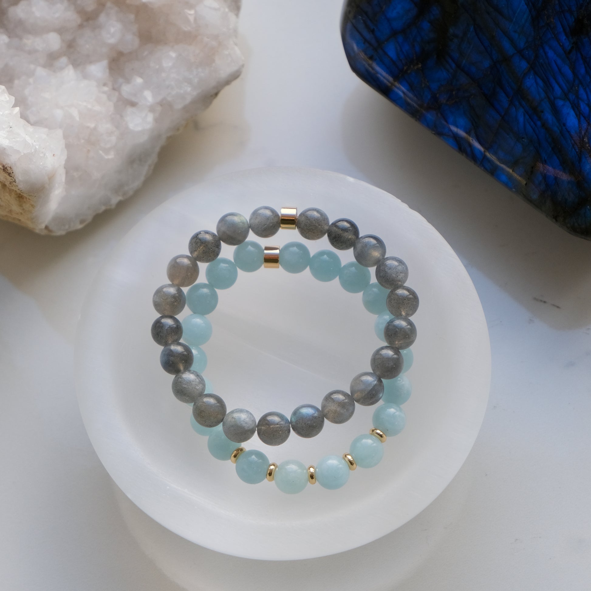 A selenite crystal charging bowl with crystal bracelets inside