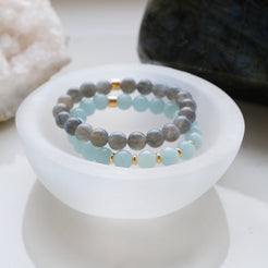 A selenite crystal charging bowl with crystal bracelets inside