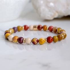 A 6mm mookaite gemstone bracelet with gold accessories