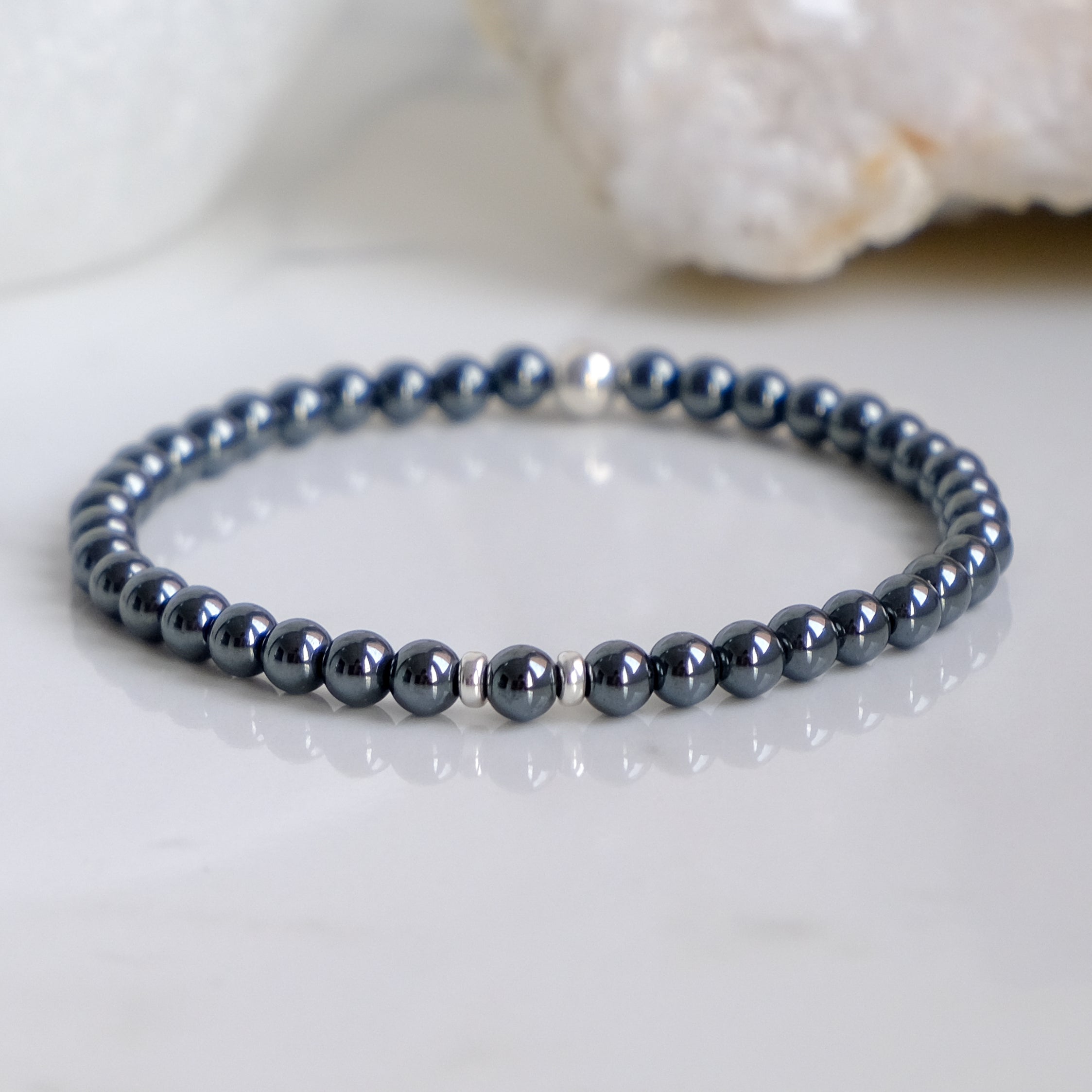 A 4mm hematite gemstone bracelet with silver accessories