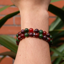 Two Unity in love gemstone bracelets worn on a model's wrist