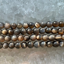 A close up of black moonstone beads