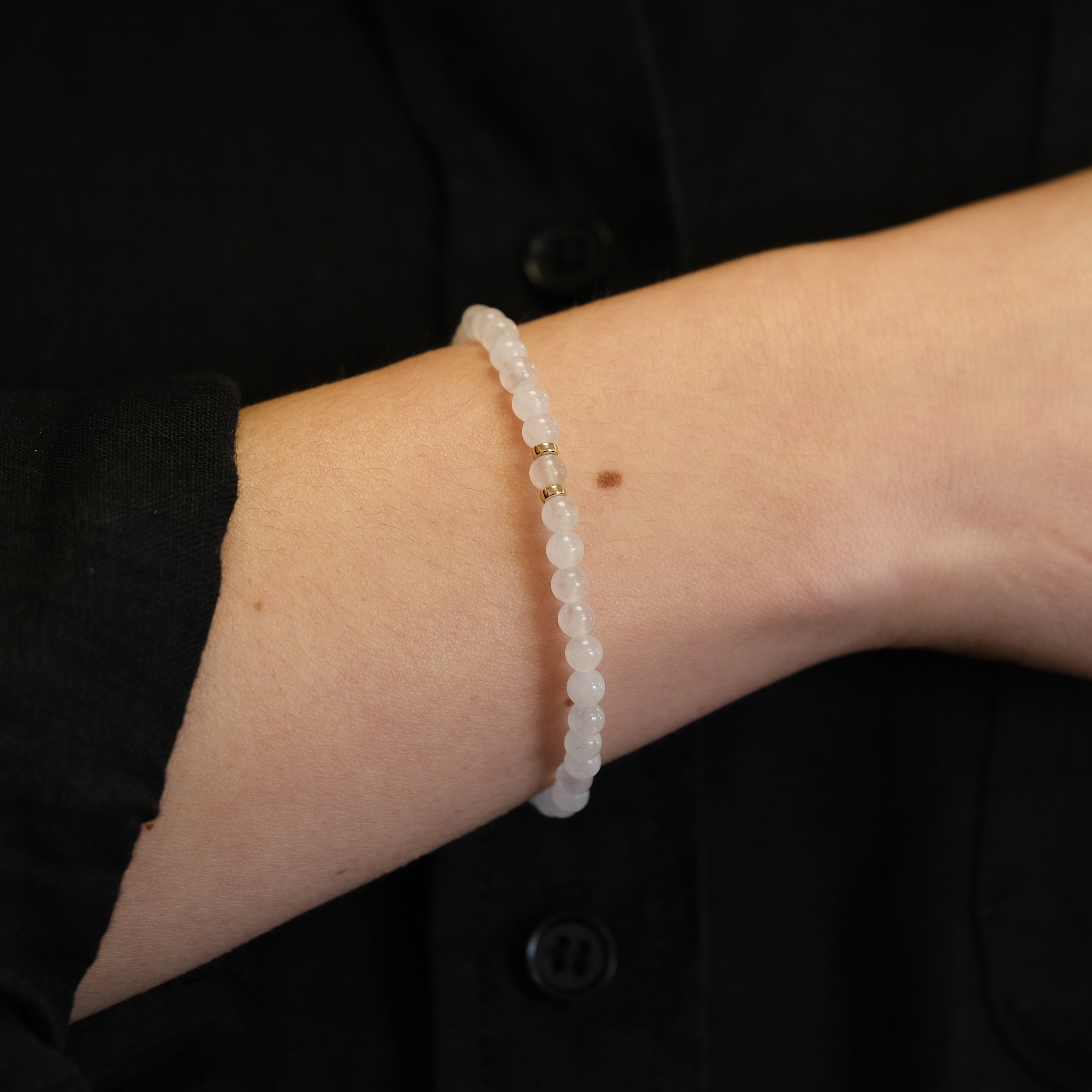 white jade 4mm gemstone bracelet being worn on wrist